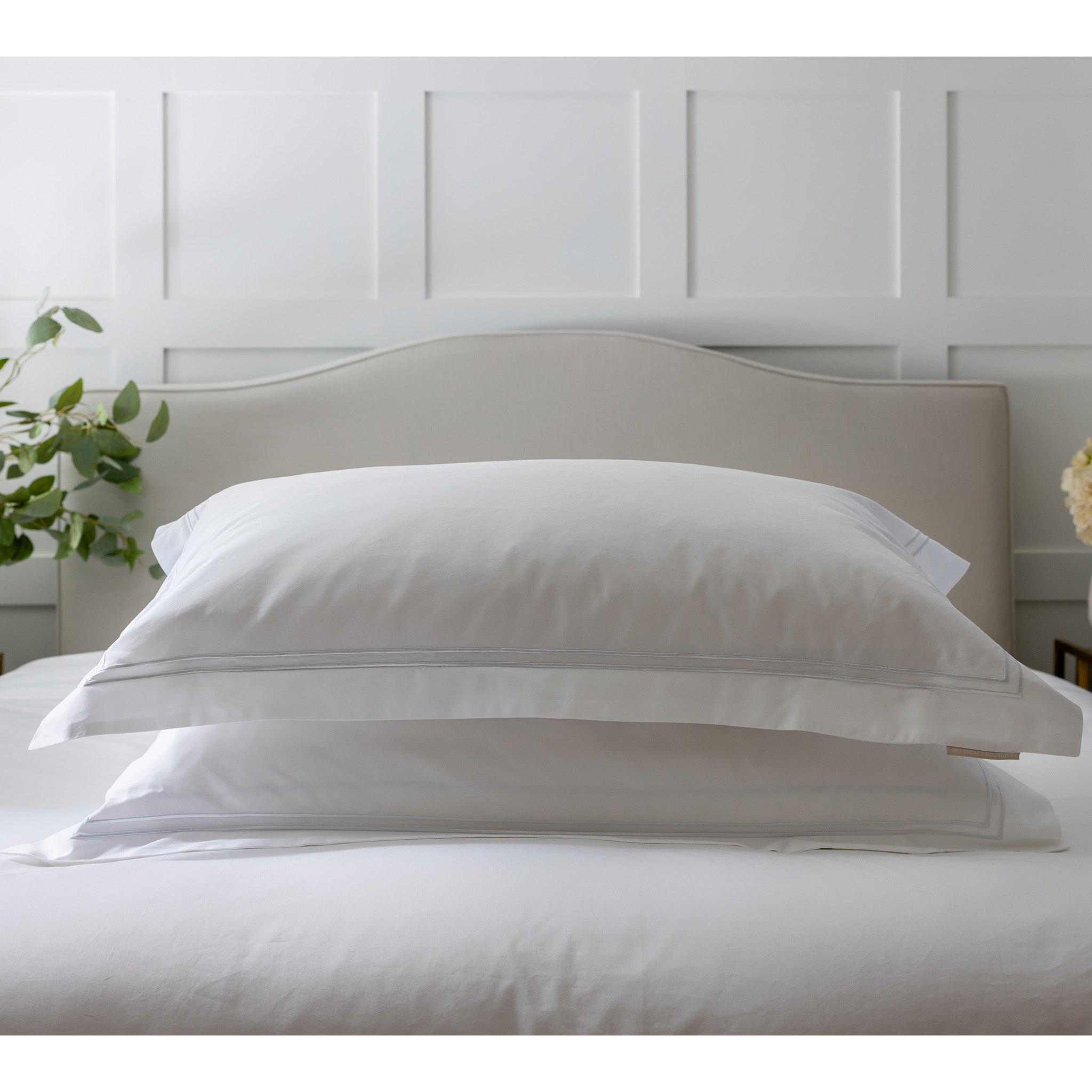 Introducing our first bedding collection by My Secret Sleep. Luxuriously designed with smooth and soft, pure white cotton sateen, in 600 thread count. Finished with a white double row cord embroidered edge. Pillowcases with a deep envelope close for ease and convenience. Pillow Case Dimensions:  Standard: W50cm x L75cm (Plus 5cm border)  Super King: W50cm x L90cm (Plus 5cm border) Materials: 100% Cotton  Delivery: 2-3 Working days